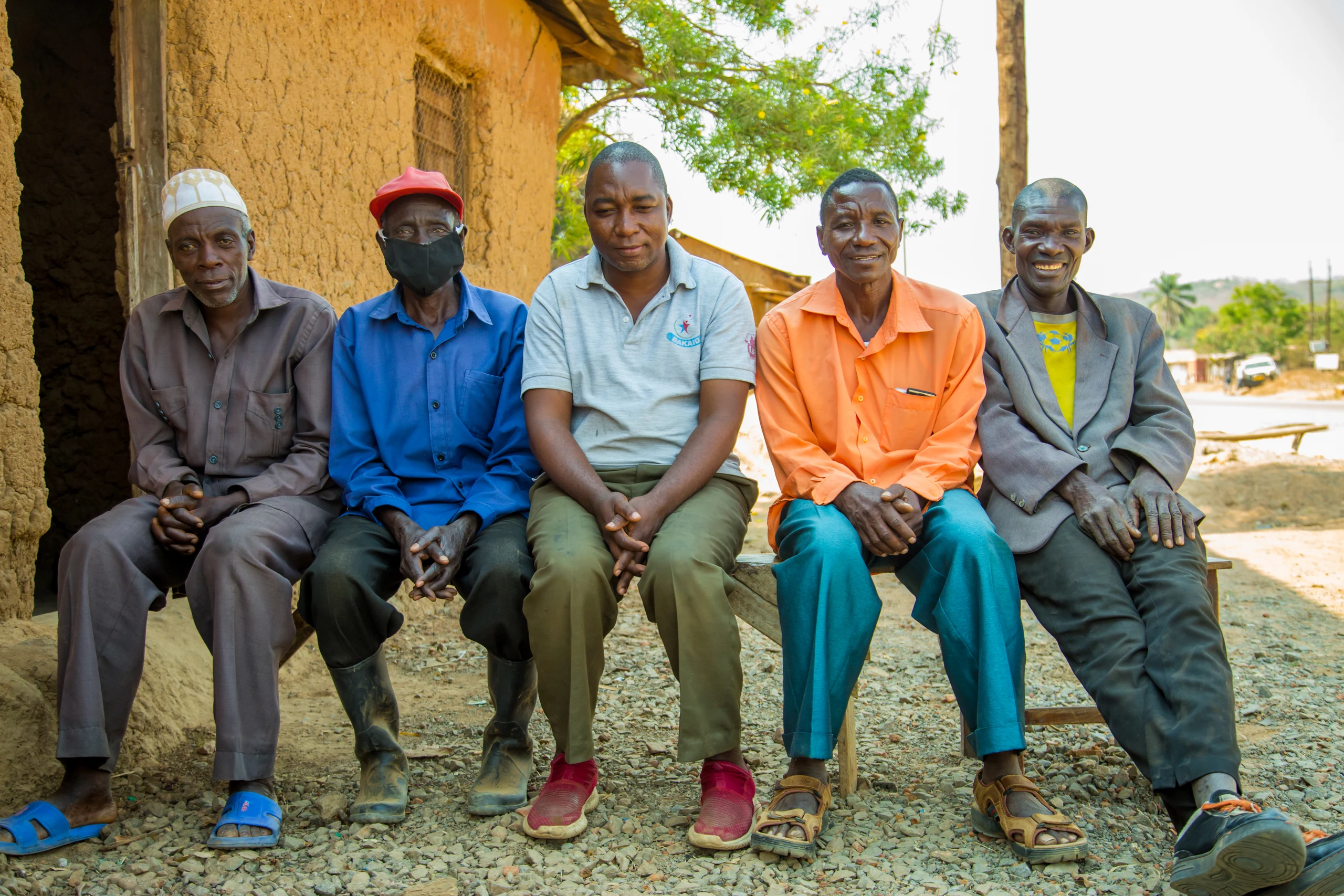 A group of beekeepers sitting together outside